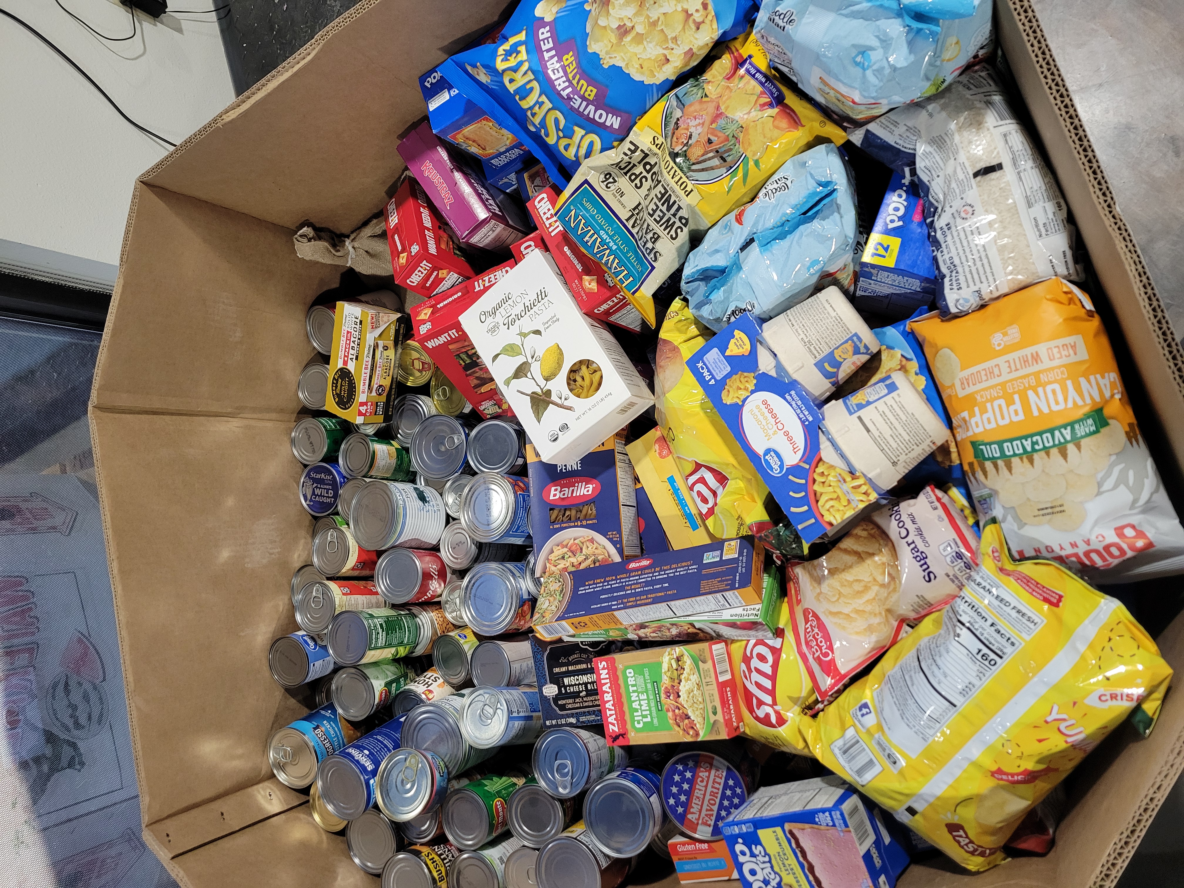 Various dry goods in a cardboard container.